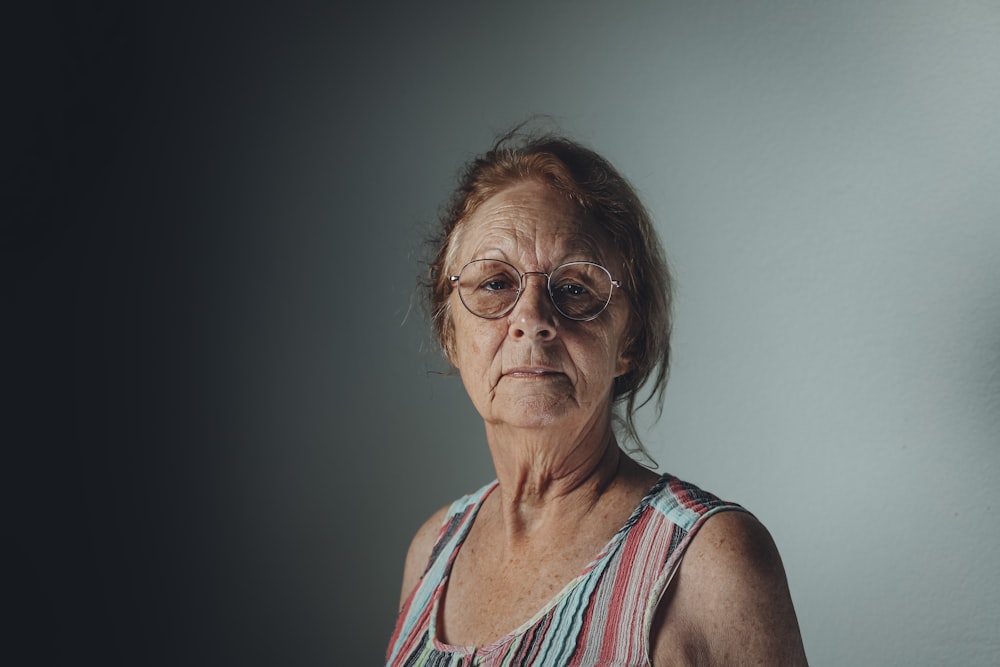 an older woman with glasses looking at the camera