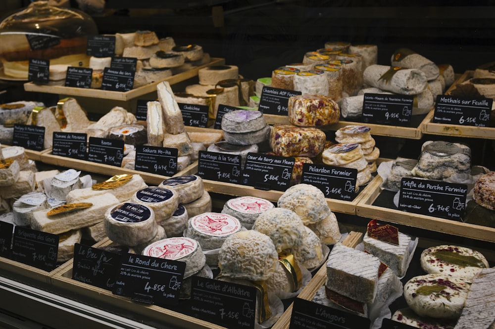 a display case filled with lots of different types of cheese