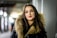 a woman in a black jacket with a fur collar