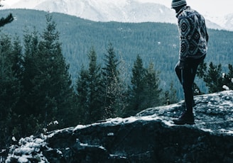 a man standing on top of a snow covered mountain