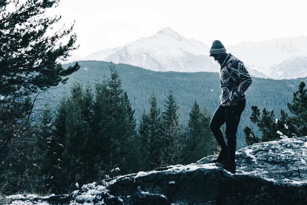 a man standing on top of a snow covered mountain