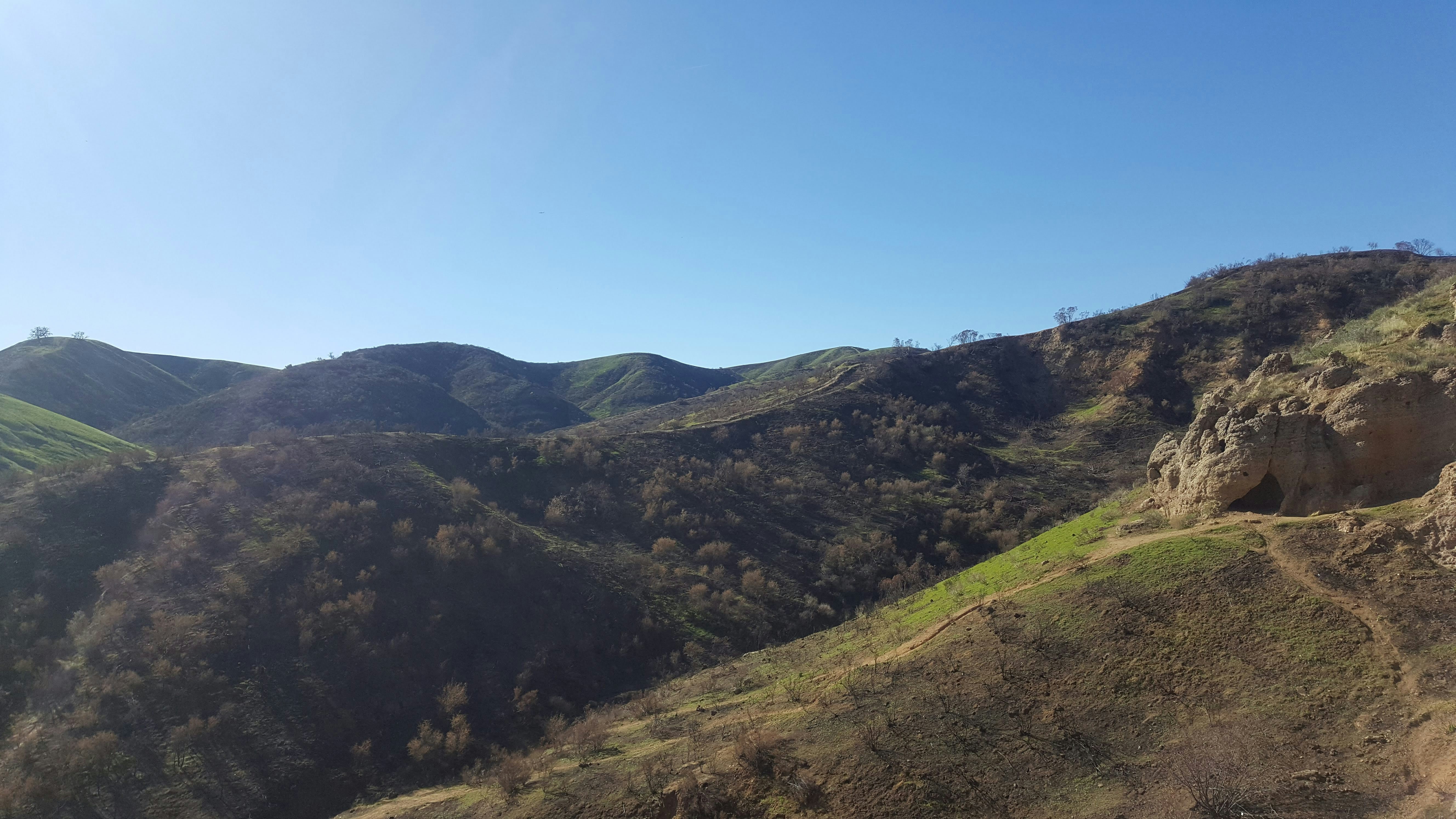 A hiker looking at a mountain range.