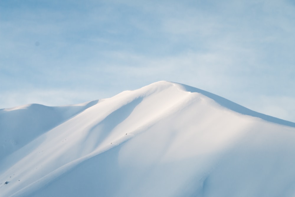 a mountain covered in snow under a blue sky