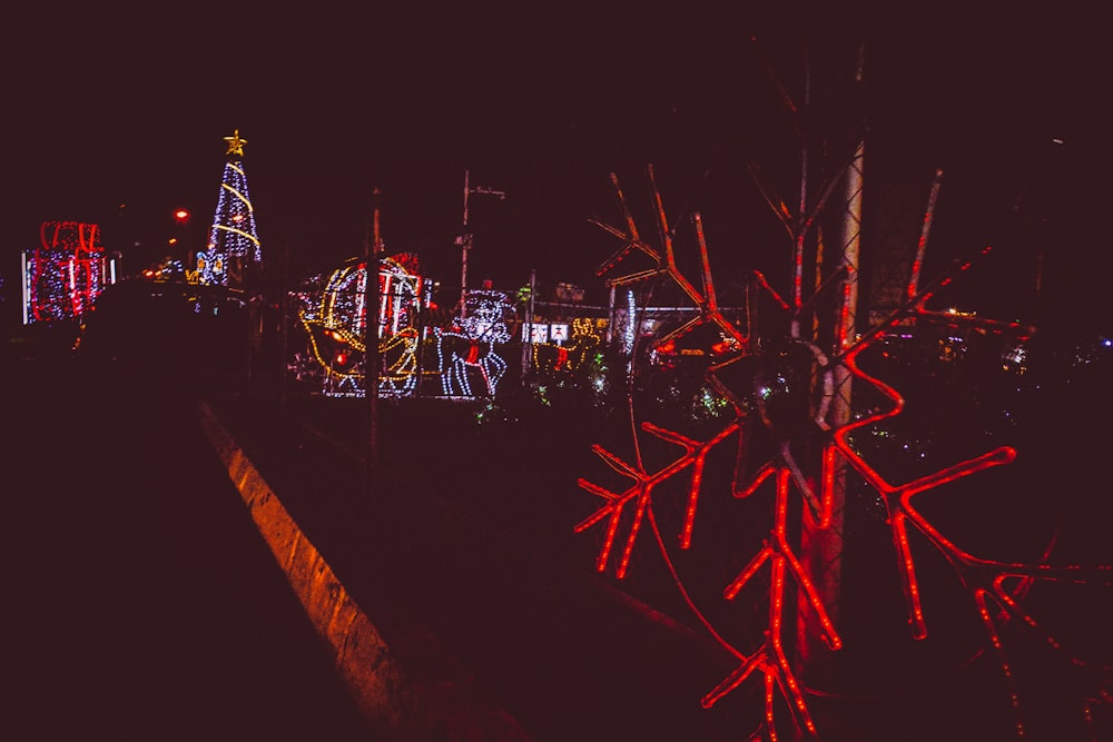 a night scene of a fairground with a lot of lights