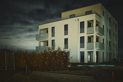 a tall white building with balconies on the balconies