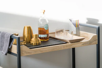 A stylish bar cart set up with glassware and bottles, ready for an evening gathering.