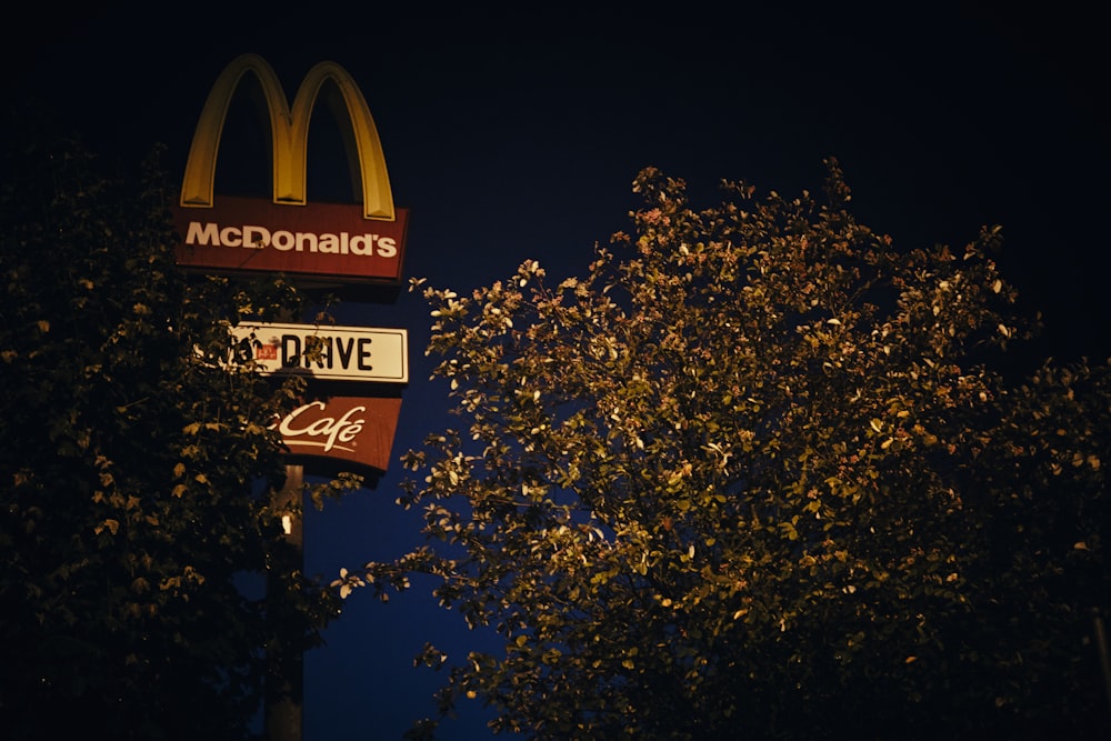 a mcdonald's sign is lit up at night