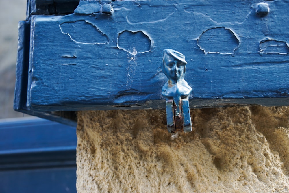 a close up of a blue door handle on a building