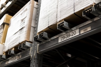 a close up of a metal shelf with boxes on it