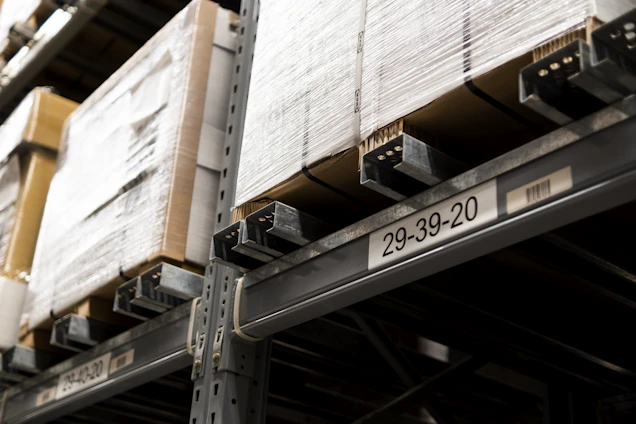 a close up of a metal shelf with boxes on it