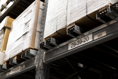 a close up of a metal shelf with boxes on it