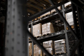 Photo of neatly stacked pallets in a spacious UK warehouse showcasing efficient logistics.