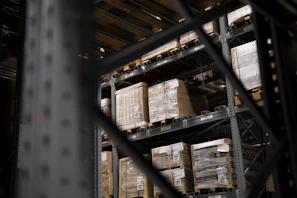 A wide shot of the Watees Goods warehouse showing various food product pallets ready for shipment.
