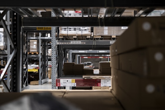 Warehouse interior with shelves filled with boxes, representing organized storage.