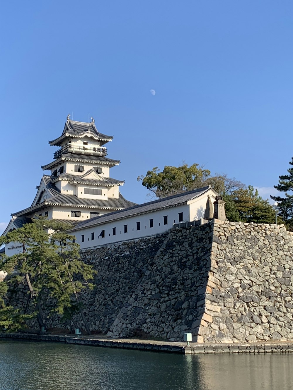 a tall building sitting on the side of a river