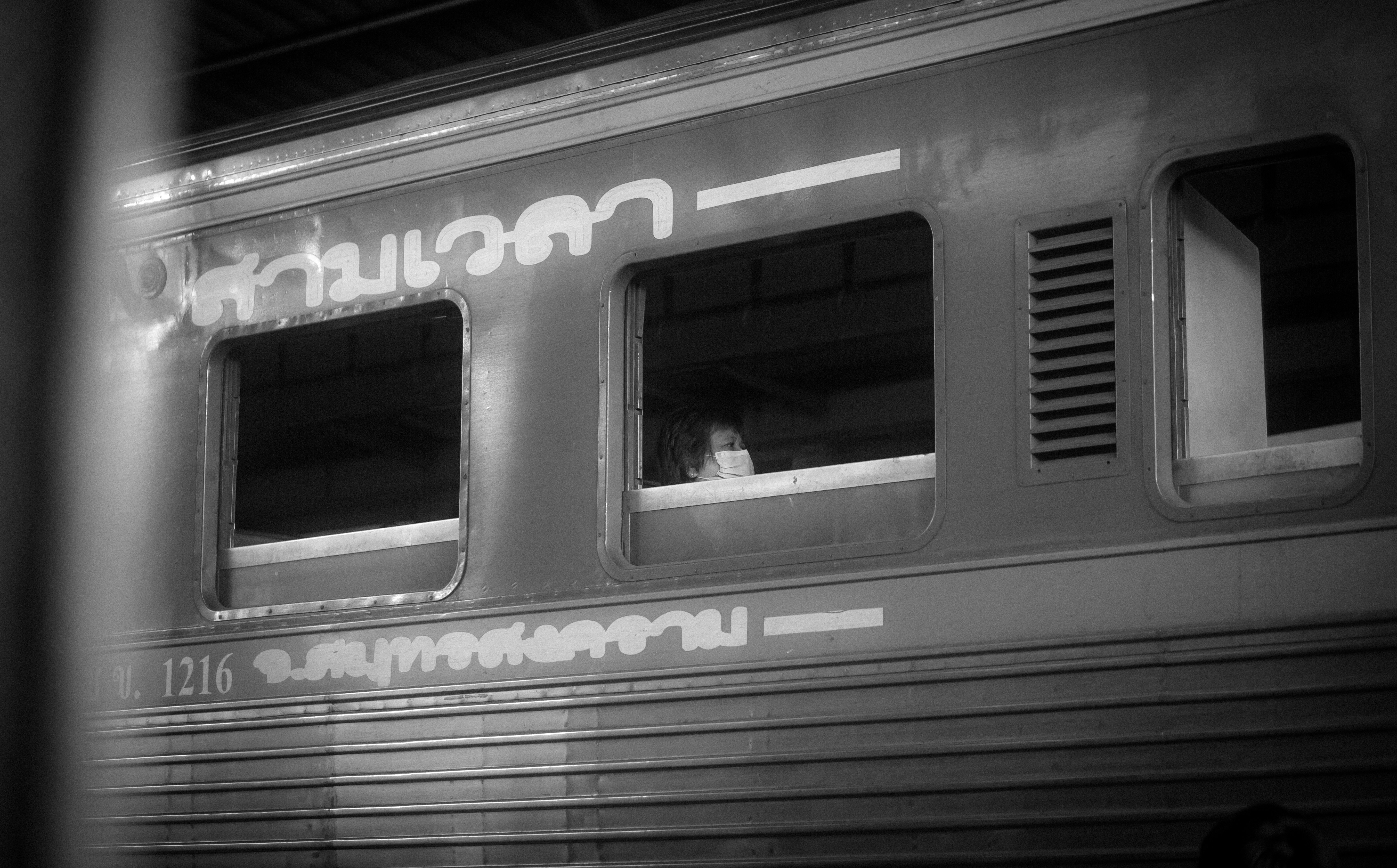 a train car with two windows and a person in the window