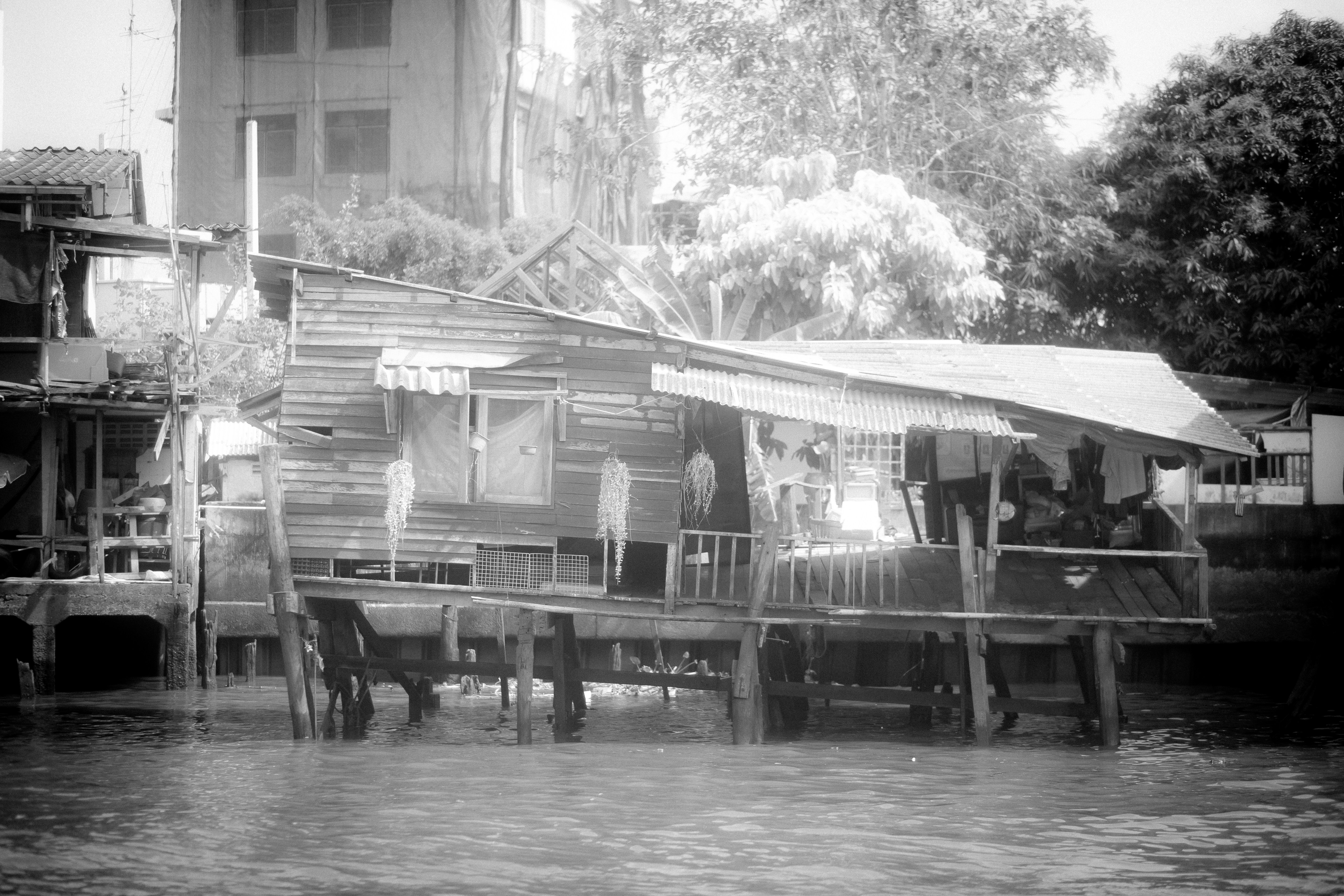 a black and white photo of a house on stilts