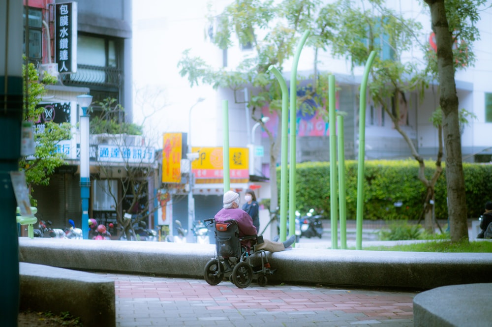 a person sitting on a bench on a city street