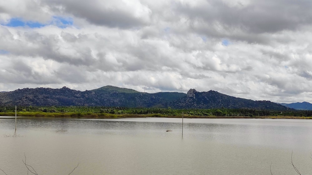 a body of water with mountains in the background