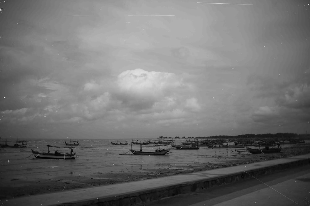 a group of boats floating on top of a body of water