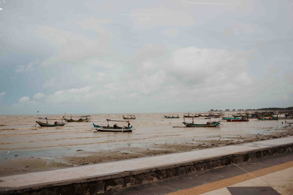 a group of boats floating on top of a river