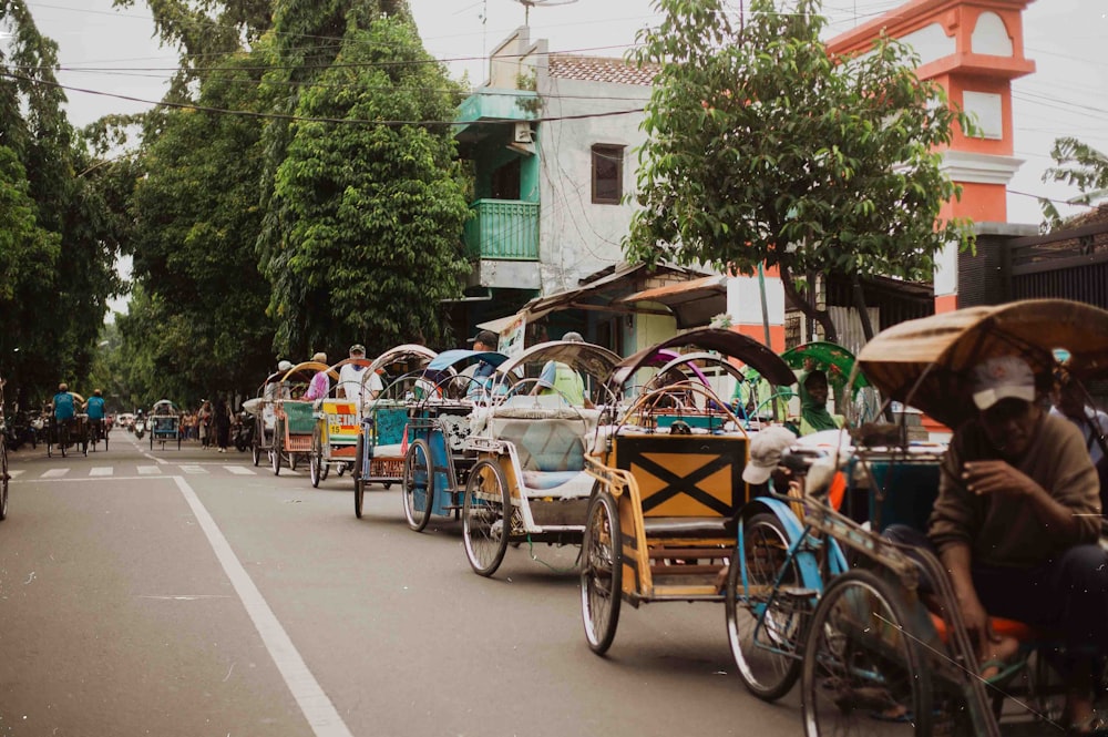 a group of people riding on the back of a horse drawn carriage down a street