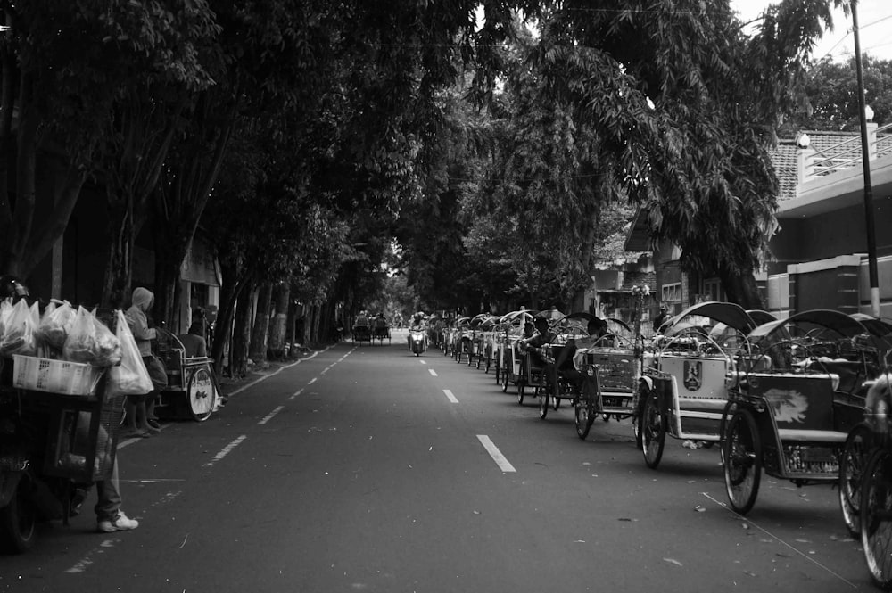 a black and white photo of a street filled with people