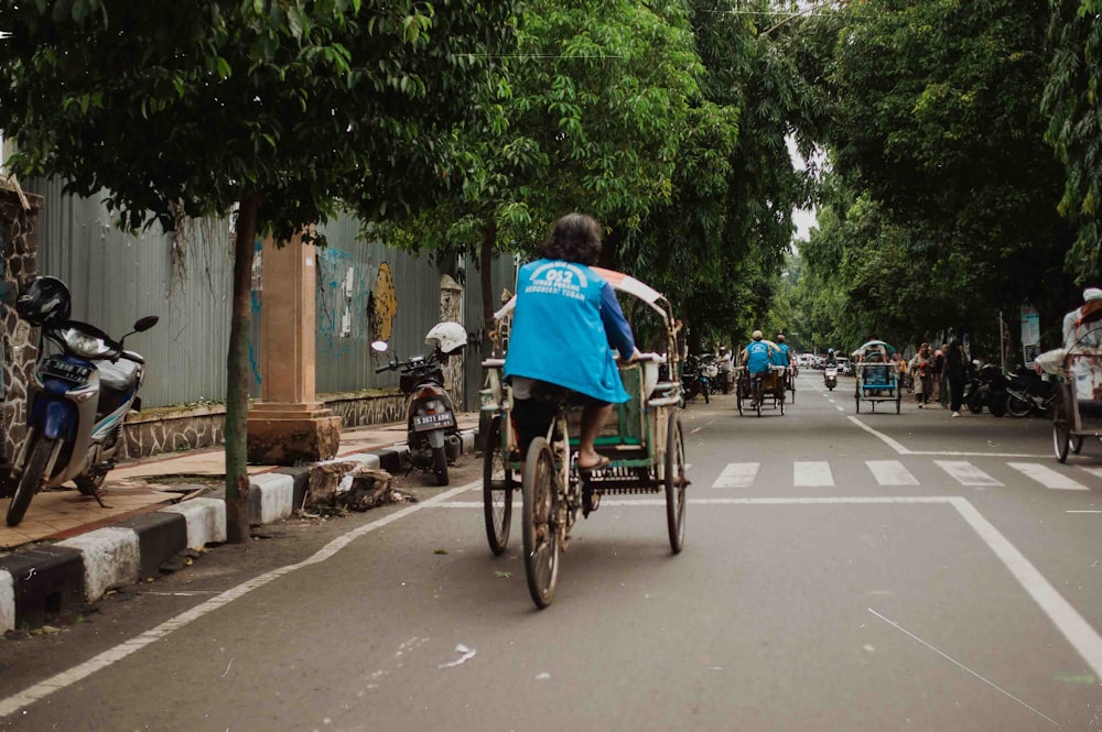 a person riding a bike down a street