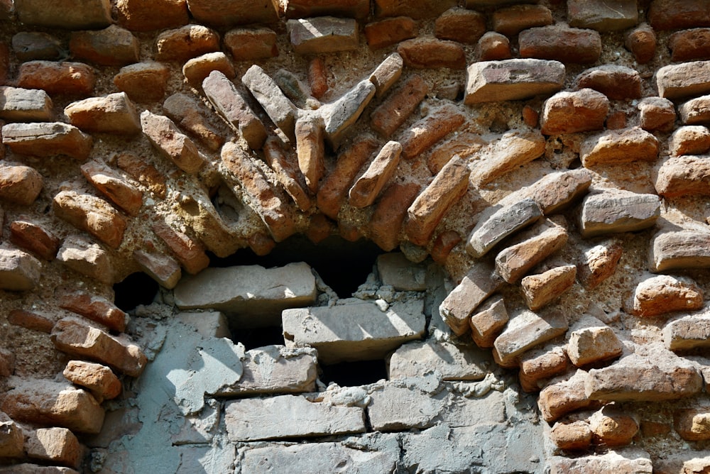 a close up of a brick wall with a hole in it