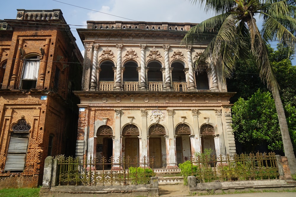 an old building with a palm tree in front of it