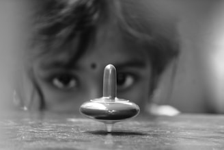 Children intensely competing in a Beyblade spinning top battle.