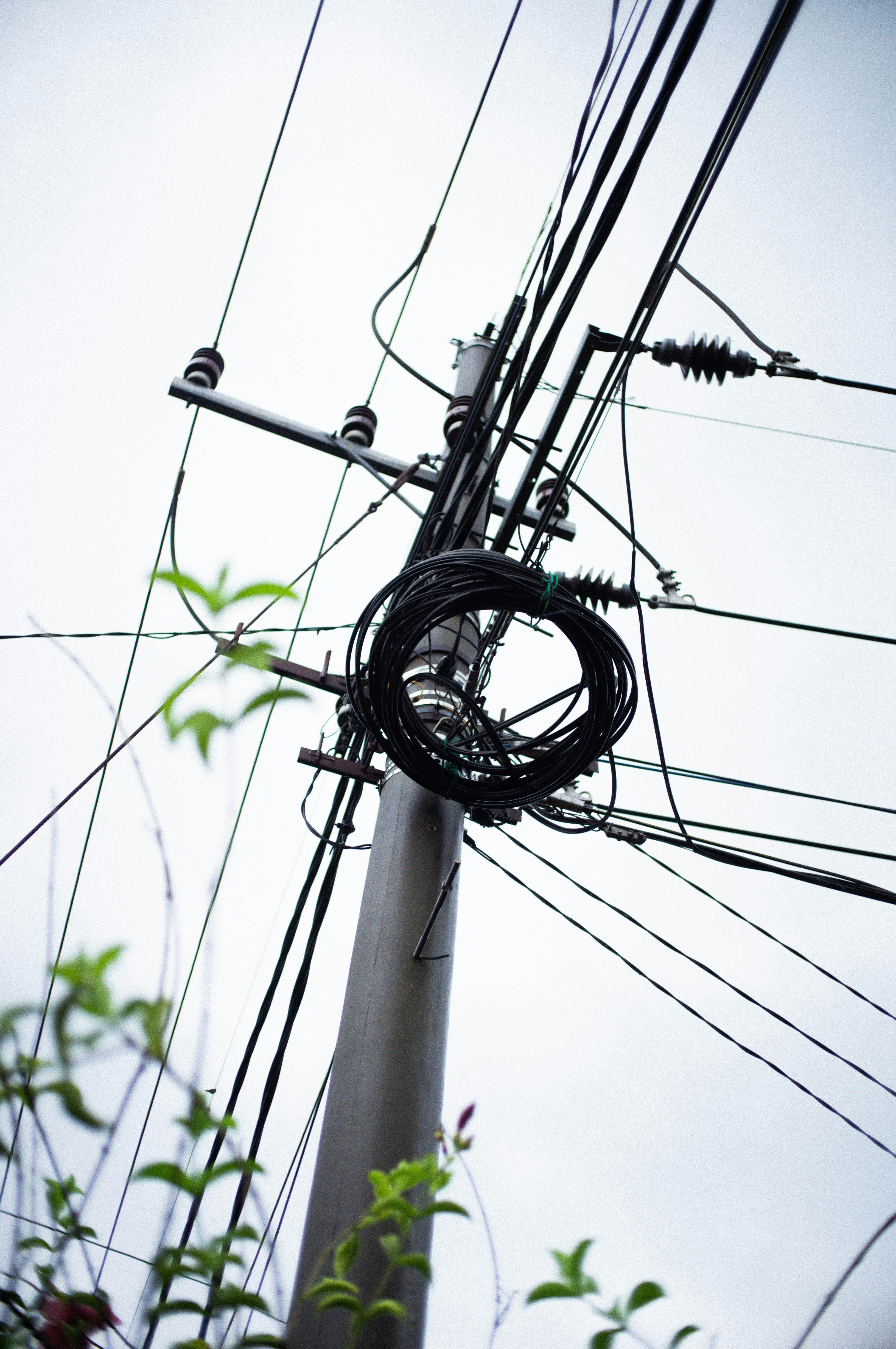 A telephone pole with a bunch of wires attached to it photo Free