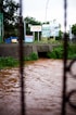 a flooded street with a bridge in the background