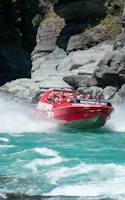 a group of people riding on the back of a red boat