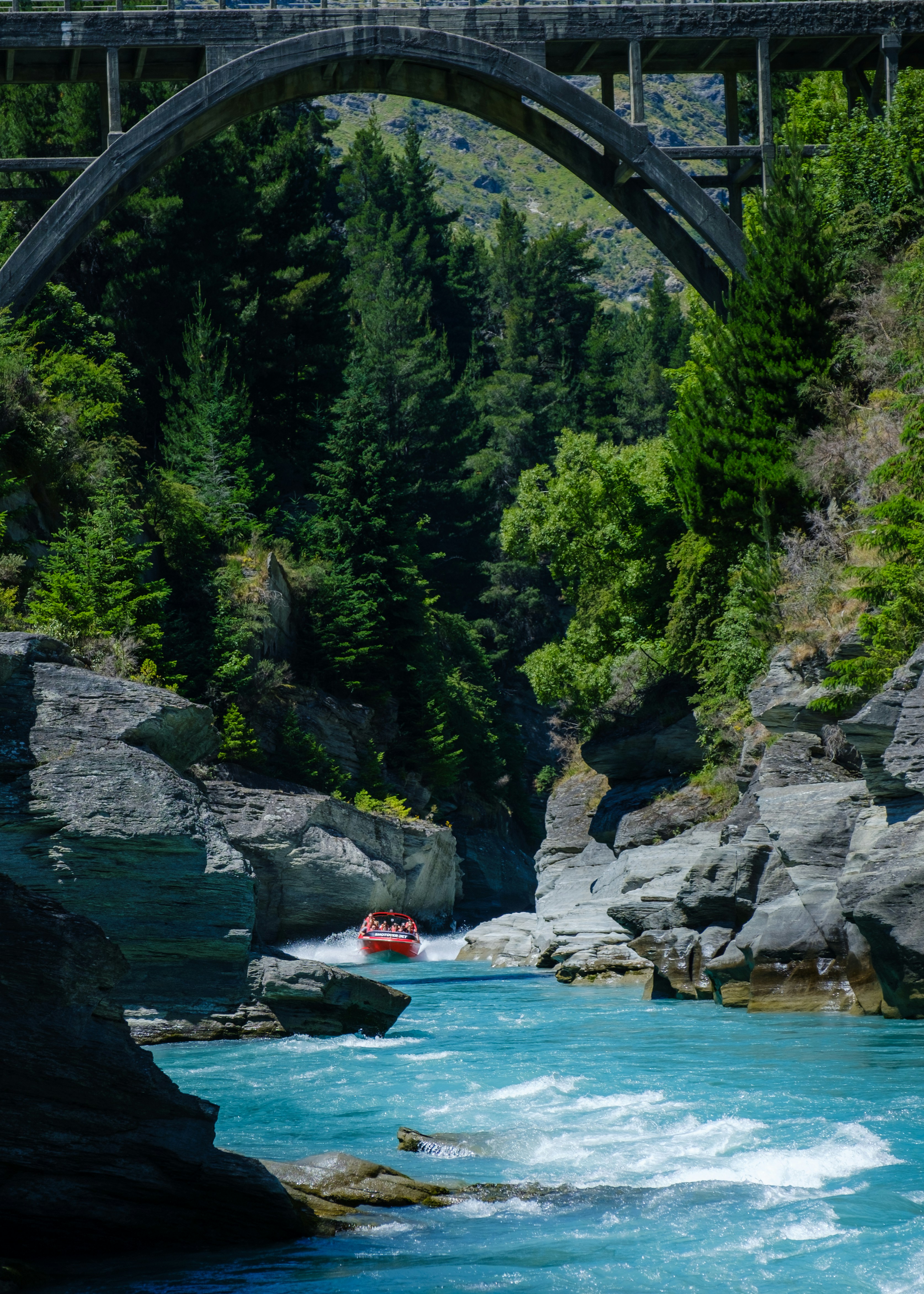 a bridge over a river with a boat in it