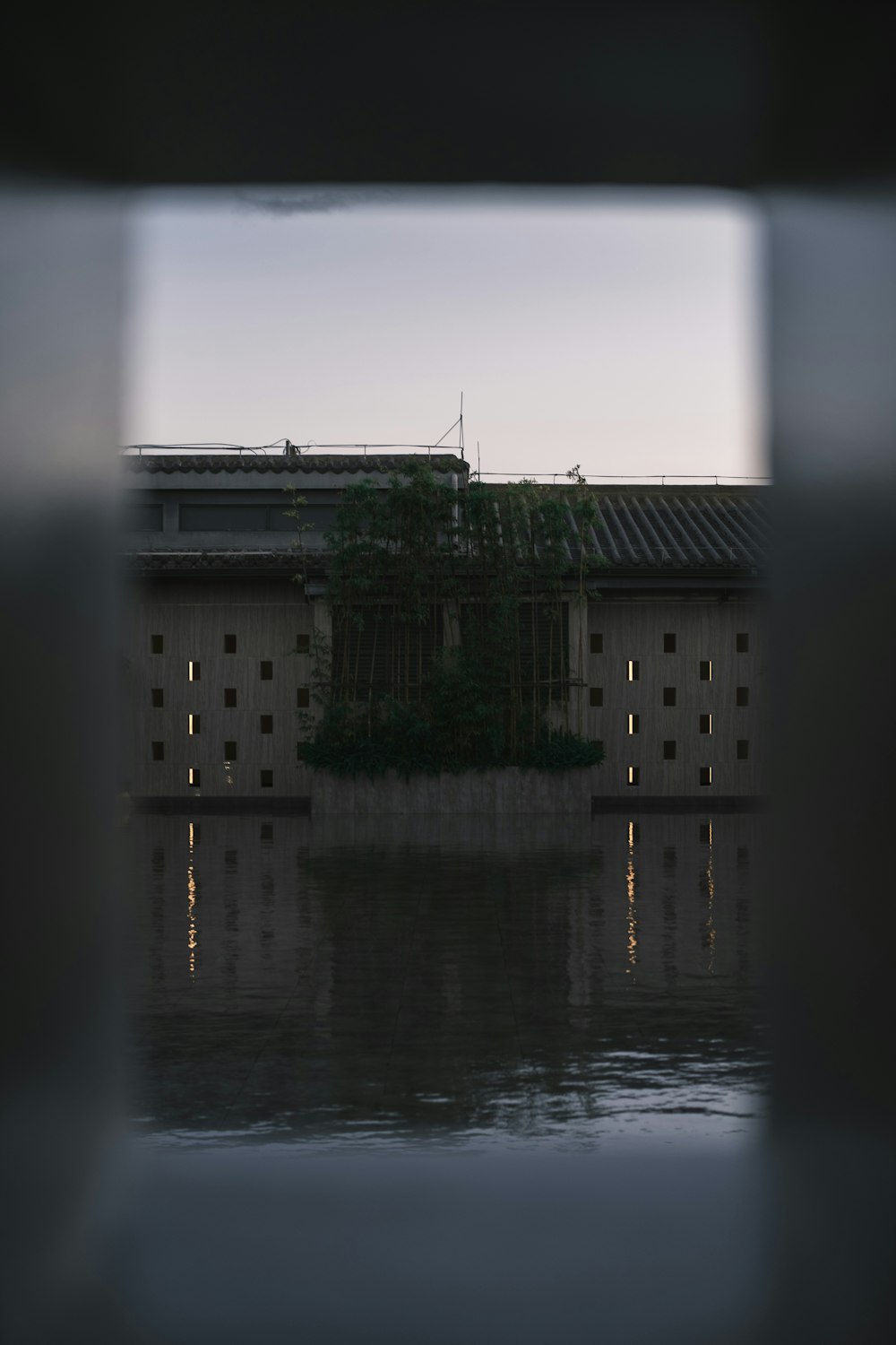 a building is seen through a window at night