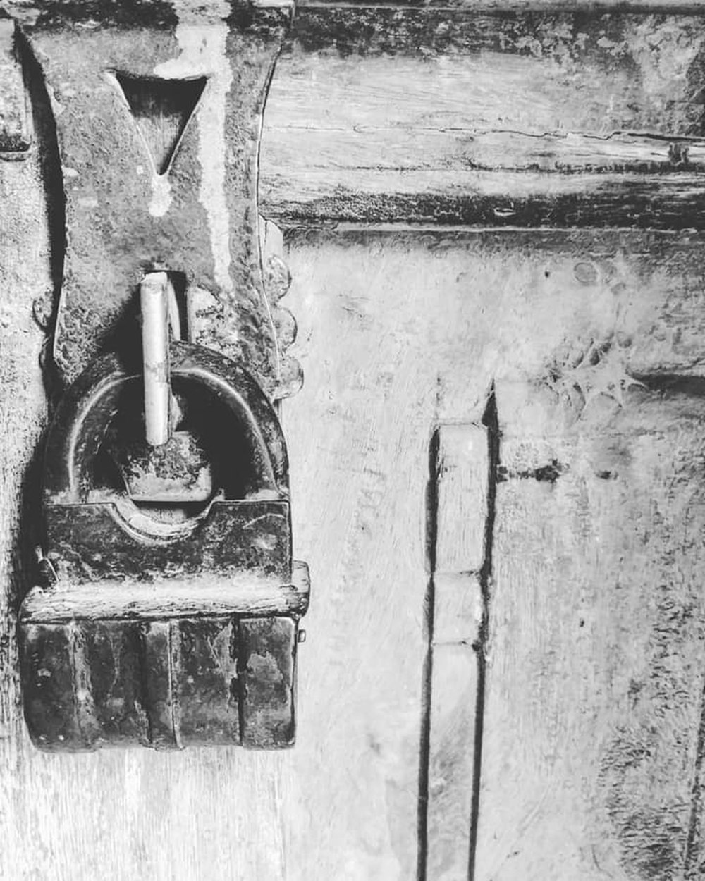 a close up of a door handle on a wooden door