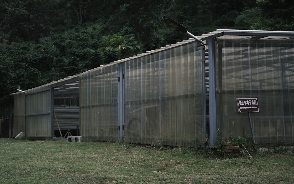 a fenced in area next to a building with a sign on it