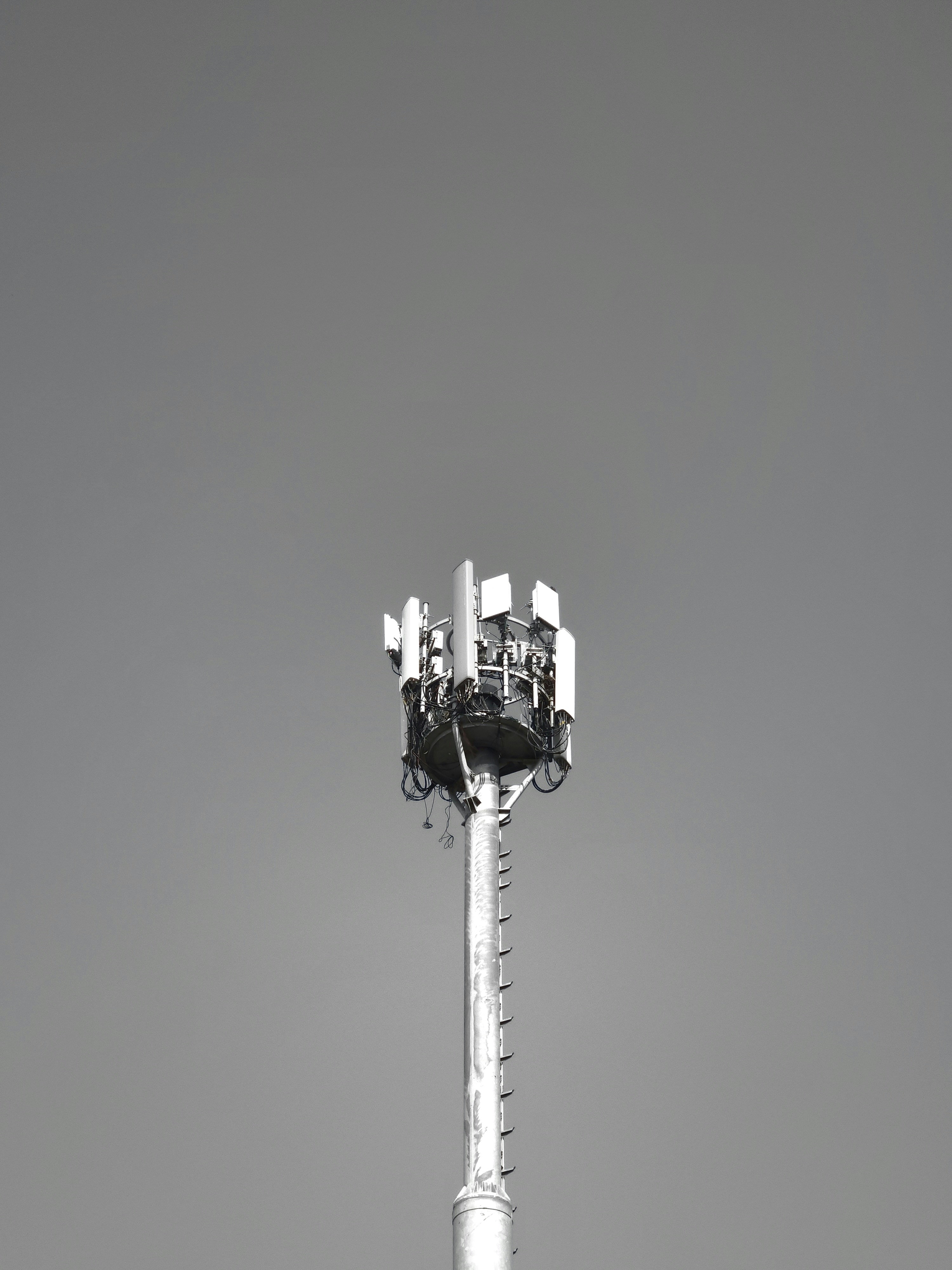 a black and white photo of a cell phone tower
