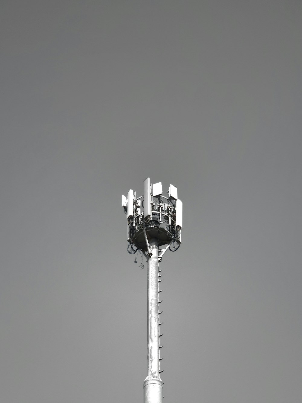 a black and white photo of a cell phone tower