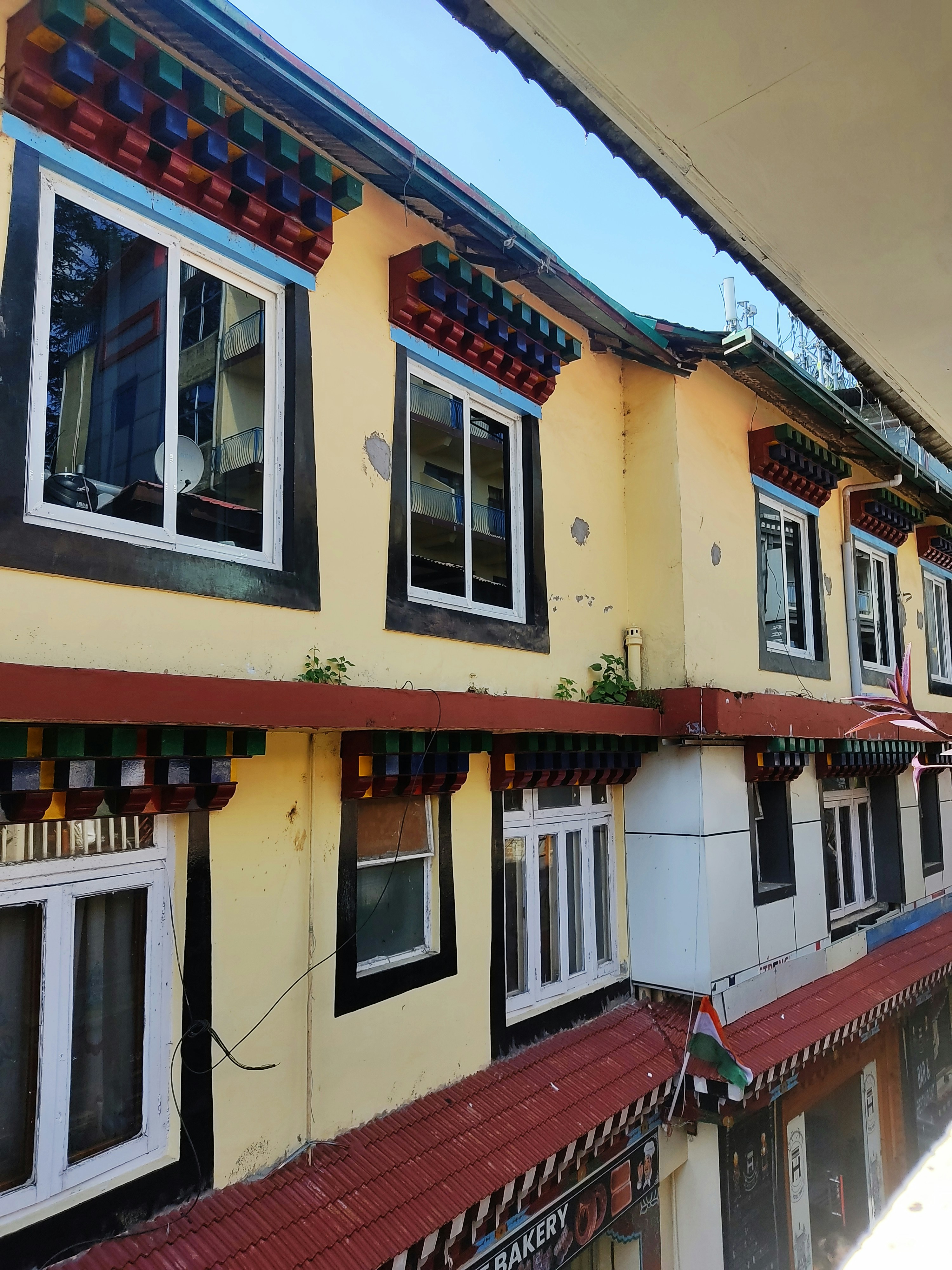 Picture of A row of multi - colored buildings with a reflection of the building ...
