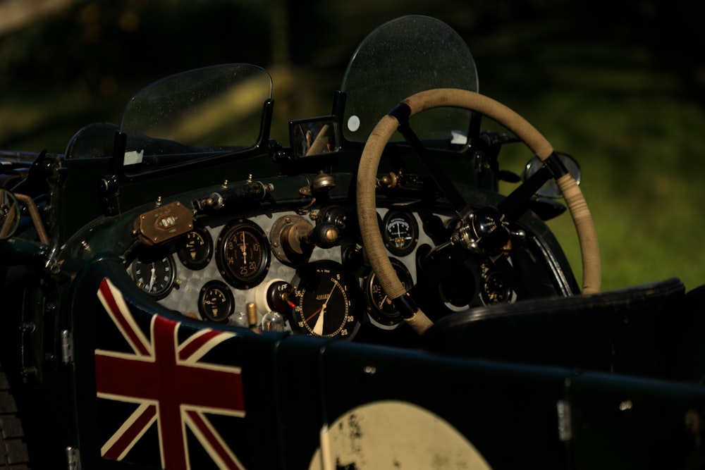 a close up of the steering wheel and dashboard of a vintage car