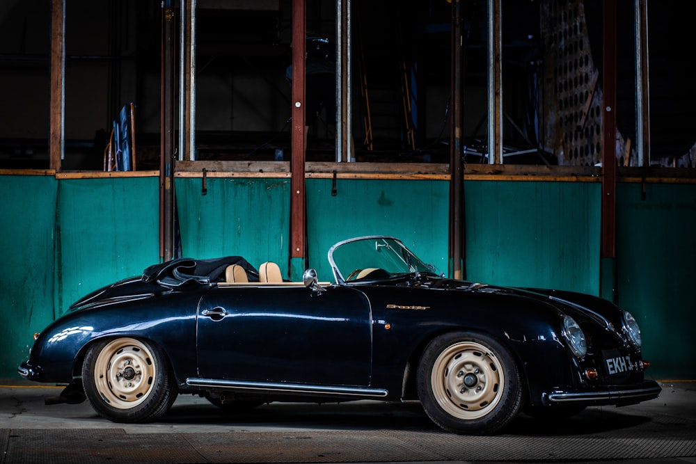 a black sports car parked in front of a building