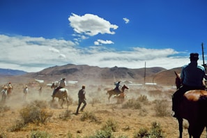 Group of riders galloping across the open Cappadocian landscape