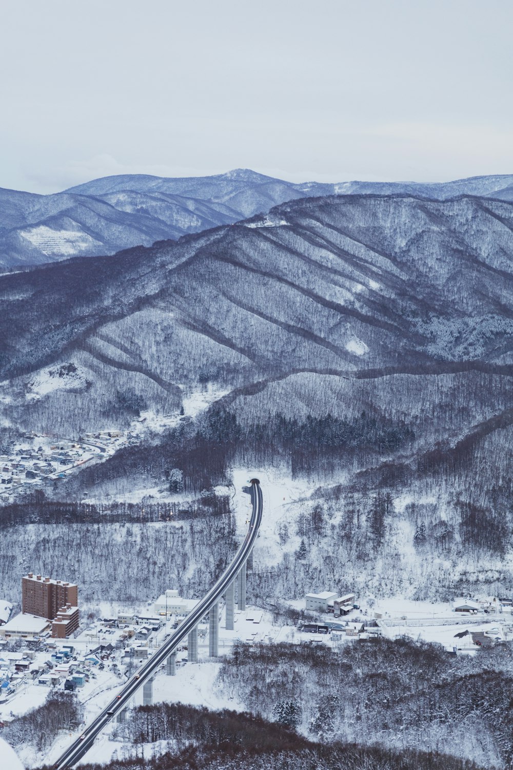 a train traveling over a snow covered mountain