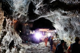 a group of people standing inside of a cave