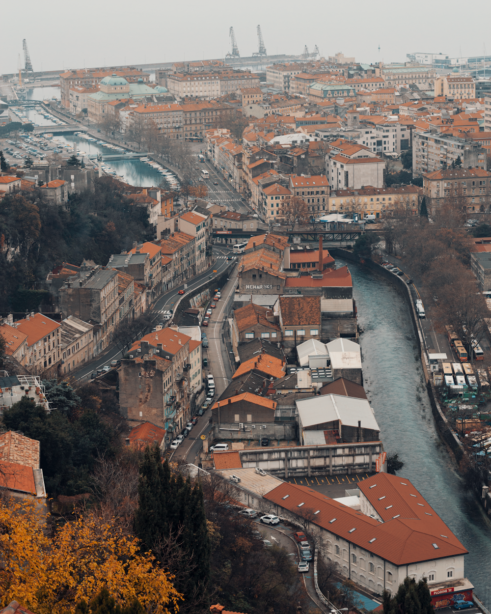 a river running through a city next to tall buildings