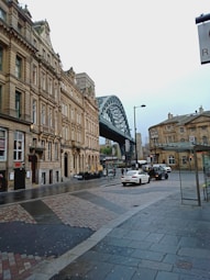 a city street with a bridge in the background