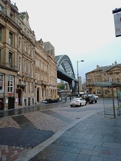 a city street with a bridge in the background