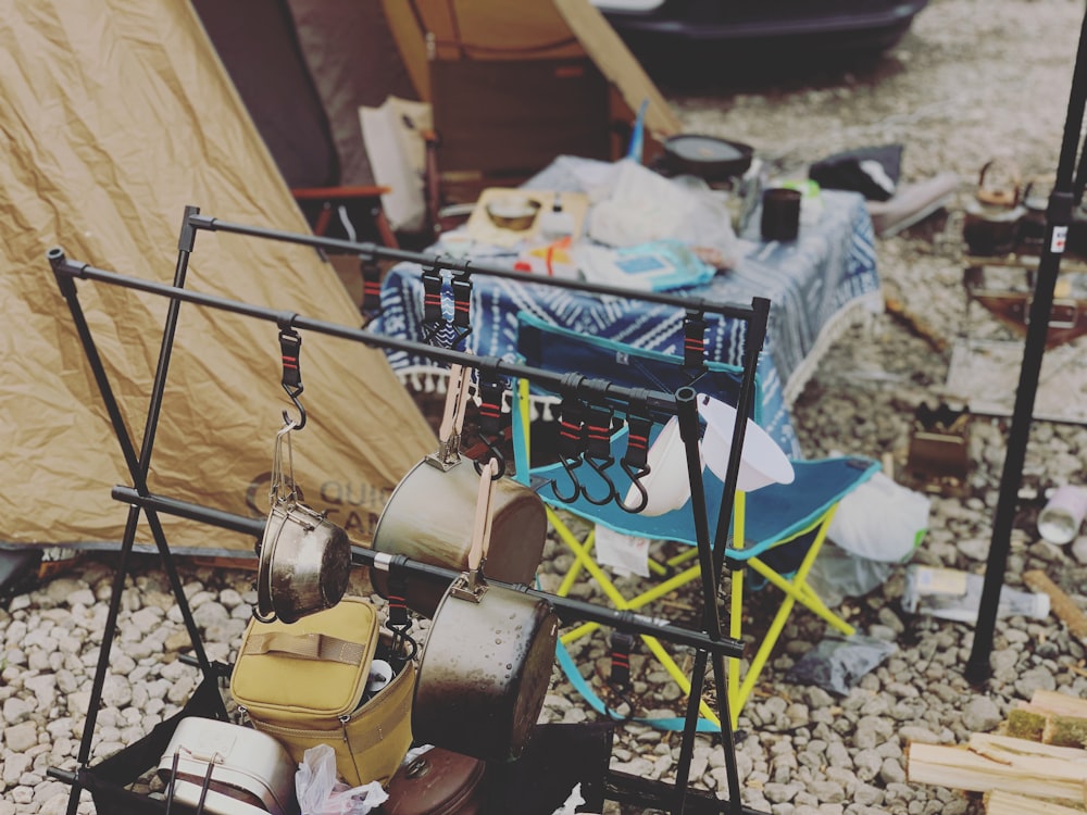 a pile of pots and pans sitting next to a tent